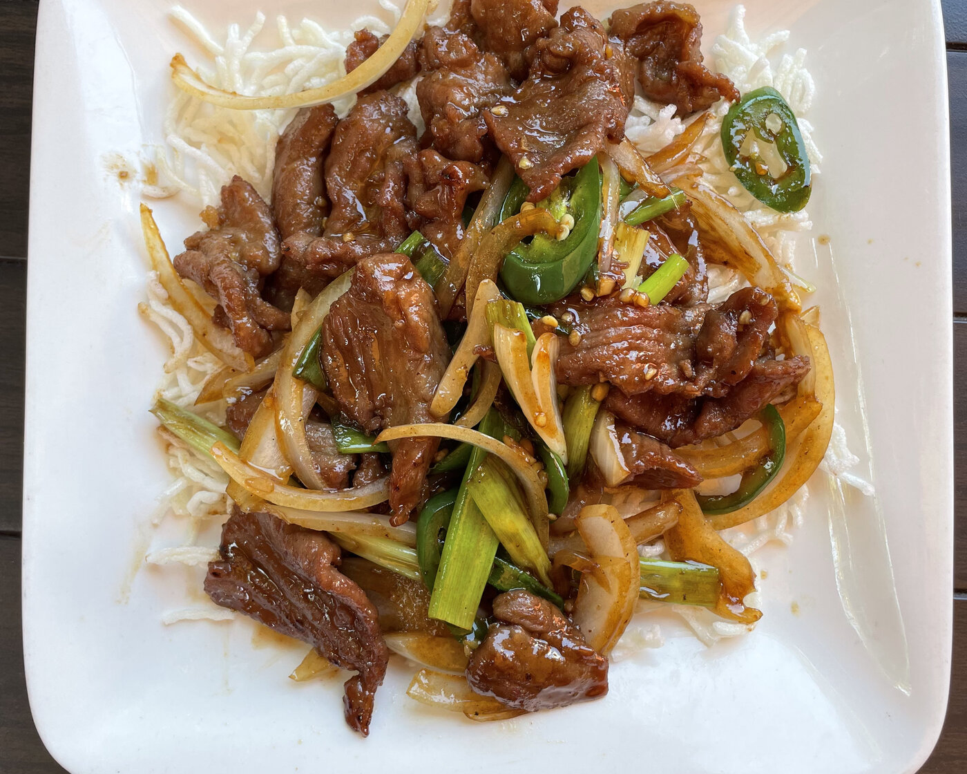 Mongolian Beef with scallion and jalapeño over crispy noodles